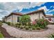 Exterior home view showing a brick paved walkway and well-manicured landscaping and a two car garage at 10410 Inglenook Ter, Palmetto, FL 34221