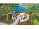 Aerial view of a cozy community fire pit with comfortable seating and lush landscaping at 10410 Inglenook Ter, Palmetto, FL 34221