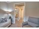 Hallway with wood-look tile flooring that leads to the bedroom and ensuite bathroom at 10410 Inglenook Ter, Palmetto, FL 34221