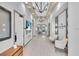 Well-lit hallway featuring modern decor, comfortable seating, and elegant design at 10410 Inglenook Ter, Palmetto, FL 34221