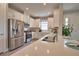 Bright kitchen featuring stainless steel appliances, recessed lighting, and a large island overlooking the breakfast bar at 10410 Inglenook Ter, Palmetto, FL 34221
