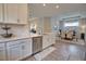 Well-appointed kitchen with stainless steel dishwasher and bright white counters open to the dining area for seamless entertaining at 10410 Inglenook Ter, Palmetto, FL 34221