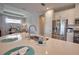 Spacious kitchen features a stainless steel refrigerator, a large island, and modern fixtures open to the dining area at 10410 Inglenook Ter, Palmetto, FL 34221