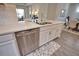 Kitchen island with stainless steel dishwasher and white cabinetry overlooking dining room is an ideal set-up for modern living at 10410 Inglenook Ter, Palmetto, FL 34221