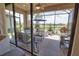 Enjoy the picturesque lake views in this screened lanai with beautiful wicker furniture, perfect for outdoor dining at 10410 Inglenook Ter, Palmetto, FL 34221
