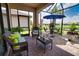 Relax and unwind on this screened-in lanai with wicker furniture and views of the serene backyard at 10410 Inglenook Ter, Palmetto, FL 34221