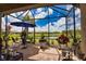 This charming screened lanai features brick flooring and overlooks a scenic pond, offering a peaceful retreat at 10410 Inglenook Ter, Palmetto, FL 34221