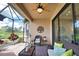 Screened lanai features comfortable seating and views of the expansive backyard and lush greenery at 10410 Inglenook Ter, Palmetto, FL 34221