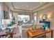 Bright living room featuring tray ceilings, neutral walls, tile floors, stylish furnishings, and sliding glass doors at 10410 Inglenook Ter, Palmetto, FL 34221