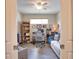 Bright home office features wood-look tile flooring, a ceiling fan, and a comfortable sofa for reading at 10410 Inglenook Ter, Palmetto, FL 34221