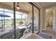 Screened patio with brick flooring features beautiful lake views and ample seating for entertaining guests at 10410 Inglenook Ter, Palmetto, FL 34221