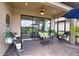 Covered patio with wicker furniture, ceiling fan, and views of the living room at 10410 Inglenook Ter, Palmetto, FL 34221