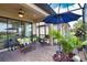 Outdoor covered patio seating area with blue umbrella and comfortable wicker furniture at 10410 Inglenook Ter, Palmetto, FL 34221