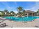 Community pool with a zero entry point, surrounded by sun loungers and palm trees at 10410 Inglenook Ter, Palmetto, FL 34221