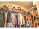Organized walk-in closet for storage with clothing and accessories at 10410 Inglenook Ter, Palmetto, FL 34221