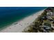 Breathtaking aerial shot of a pristine beach with clear turquoise water and coastal amenities at 10930 Lerwick Cir, Englewood, FL 34223