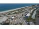 Aerial view showcasing the beach, turquoise water, and nearby coastal businesses and roundabout at 10930 Lerwick Cir, Englewood, FL 34223