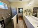 Bathroom with a large glass enclosed shower, dual sinks, and neutral color palette at 10930 Lerwick Cir, Englewood, FL 34223