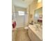 Clean bathroom with a shower-tub, vanity, and neutral color palette at 10930 Lerwick Cir, Englewood, FL 34223