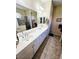 Spacious bathroom boasts double sinks, tile flooring, and ample counter space at 10930 Lerwick Cir, Englewood, FL 34223