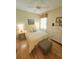 Cozy bedroom features hardwood floors, soft lighting, and bright windows at 10930 Lerwick Cir, Englewood, FL 34223