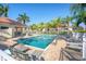 Refreshing community pool surrounded by lounge chairs, palm trees, and well-maintained landscaping at 10930 Lerwick Cir, Englewood, FL 34223