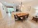 Dining area features a wooden table with seating for six, adjacent to the kitchen at 10930 Lerwick Cir, Englewood, FL 34223