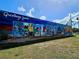 Colorful 'Greetings from Englewood' mural, showcasing local wildlife and scenic beauty at 10930 Lerwick Cir, Englewood, FL 34223