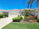Charming single-story home featuring a red tile roof, two-car garage, and vibrant landscaping at 10930 Lerwick Cir, Englewood, FL 34223