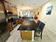 Open kitchen boasts wood cabinets, granite counters, and a breakfast bar with seating at 10930 Lerwick Cir, Englewood, FL 34223