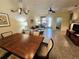Open-concept living and dining area featuring tile floors and neutral paint, with rear access to the patio at 10930 Lerwick Cir, Englewood, FL 34223