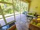 Screened patio featuring tile flooring and outdoor seating, perfect for relaxation at 10930 Lerwick Cir, Englewood, FL 34223