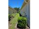 Manicured side yard showcasing green bushes and fresh mulch, defining the property line at 10930 Lerwick Cir, Englewood, FL 34223