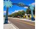 West Dearborn Street entryway featuring palm tree adorned sign, marking the entrance to Englewood at 10930 Lerwick Cir, Englewood, FL 34223