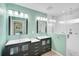 Bright bathroom with dual vanities, modern fixtures, and a glass-enclosed shower at 1099 Nokomis S Ave, Venice, FL 34285