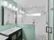 Modern bathroom with stylish shower, white tile, and unique stone floor at 1099 Nokomis S Ave, Venice, FL 34285