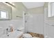 Classic bathroom with a shower, featuring white tile and a sink with natural light at 1099 Nokomis S Ave, Venice, FL 34285