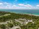 Expansive aerial view featuring the pristine beach, a pier, and a park at 1099 Nokomis S Ave, Venice, FL 34285