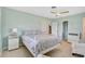 Comfortable bedroom with a white bed, light hardwood floors, and ample natural light at 1099 Nokomis S Ave, Venice, FL 34285