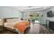 Spacious bedroom with wood floors, pool view, and access to the outdoor area at 1099 Nokomis S Ave, Venice, FL 34285