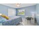 Blue bedroom featuring a window and a comfortable bed with white closet doors at 1099 Nokomis S Ave, Venice, FL 34285