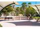 Community park featuring covered seating areas, a fountain, and lush landscaping for relaxation and enjoyment at 1099 Nokomis S Ave, Venice, FL 34285