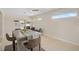 Eat-in kitchen with access to backyard pool, ceiling fan, and bar seating at 1099 Nokomis S Ave, Venice, FL 34285