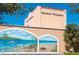 Exterior view of Venice Theatre with a colorful mural and palm trees, a cultural landmark at 1099 Nokomis S Ave, Venice, FL 34285