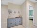 Hallway featuring a custom gray cabinet, artwork, and access to a bedroom at 1099 Nokomis S Ave, Venice, FL 34285
