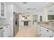 Open kitchen featuring granite countertops, stainless steel refrigerator and wine cooler at 1099 Nokomis S Ave, Venice, FL 34285