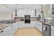 Bright kitchen featuring granite countertops, subway tile backsplash, and modern stainless steel appliances at 1099 Nokomis S Ave, Venice, FL 34285