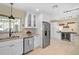 Eat-in kitchen featuring granite countertops, stainless steel appliances, and custom wine cooler at 1099 Nokomis S Ave, Venice, FL 34285