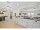 Open kitchen featuring granite countertops, white cabinets and stainless steel wine cooler at 1099 Nokomis S Ave, Venice, FL 34285