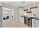 Custom built-in bar featuring floating shelves and stainless steel wine cooler at 1099 Nokomis S Ave, Venice, FL 34285